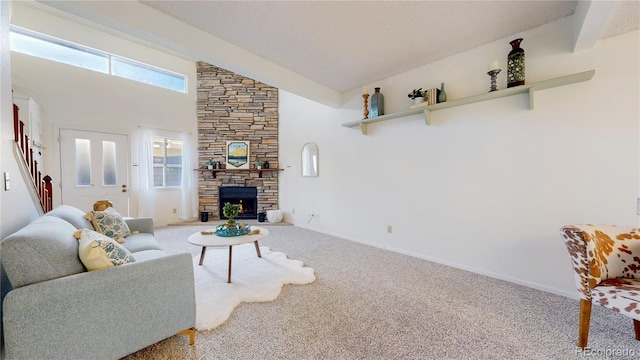 carpeted living room featuring a fireplace, a high ceiling, and beamed ceiling