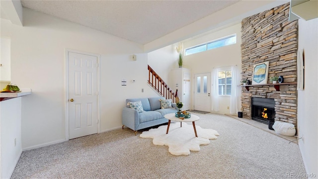 carpeted living room with a stone fireplace