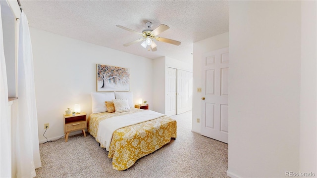 carpeted bedroom featuring ceiling fan, a closet, and a textured ceiling