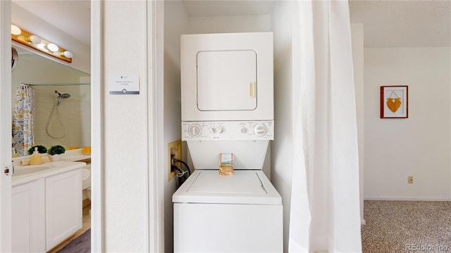 laundry room featuring sink, carpet floors, and stacked washer / dryer