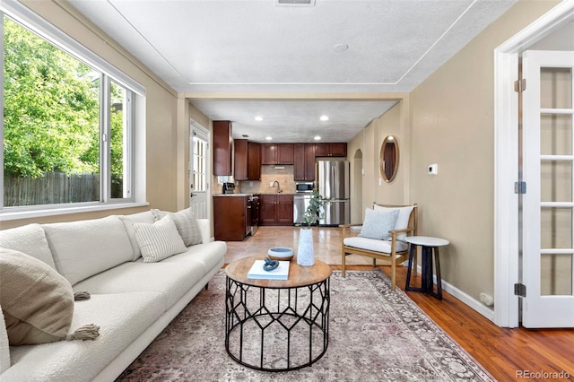 3925 Pecos St, Denver, CO 80211 - living area featuring light wood-style floors, baseboards, and recessed lighting