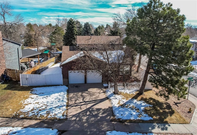 view of front of property featuring a garage, brick siding, a shingled roof, fence, and driveway