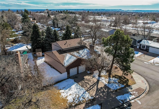 snowy aerial view with a residential view