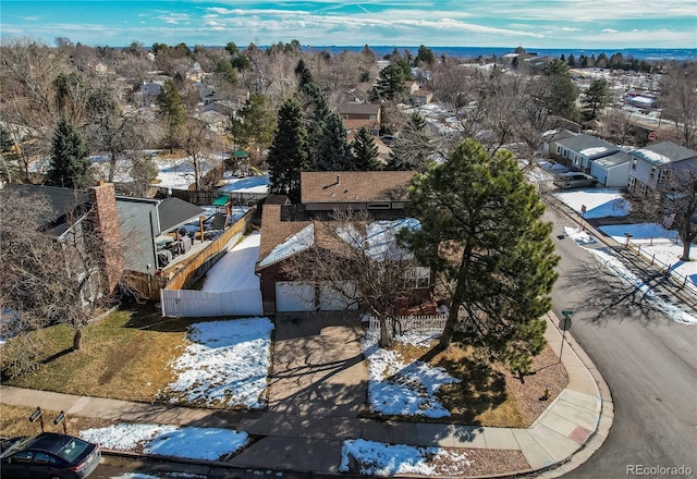 snowy aerial view featuring a residential view