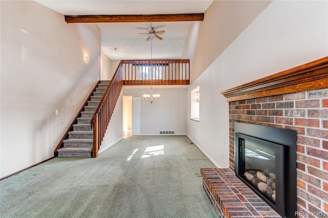 unfurnished living room with a chandelier, beamed ceiling, a fireplace, and baseboards