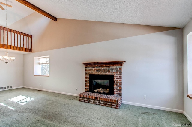 unfurnished living room featuring carpet floors, a fireplace, visible vents, baseboards, and beamed ceiling