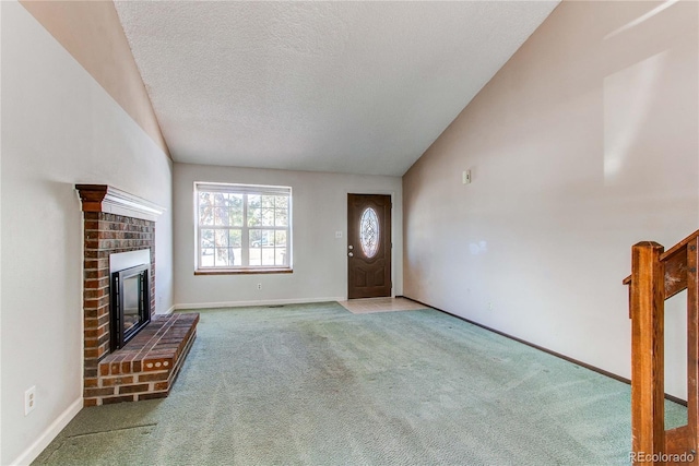 unfurnished living room featuring carpet, a fireplace, baseboards, and a textured ceiling