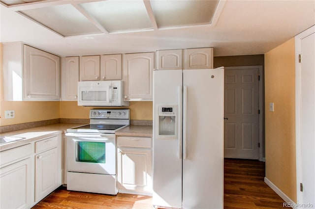 kitchen with light countertops, white appliances, light wood-type flooring, and baseboards