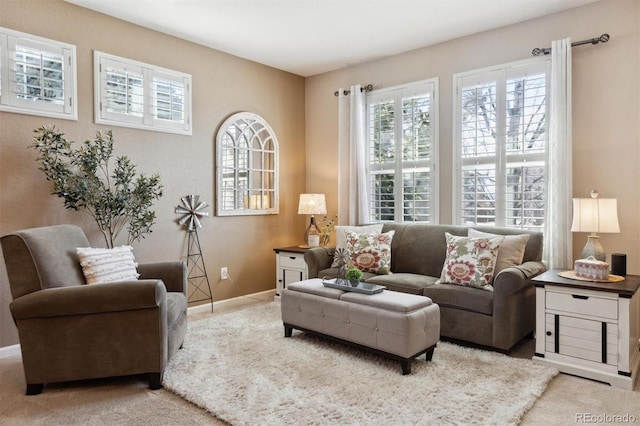 carpeted living room with baseboards