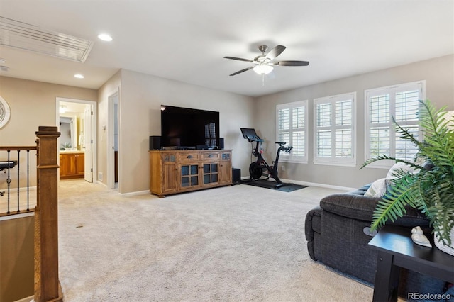 living area with light carpet, baseboards, a ceiling fan, and recessed lighting