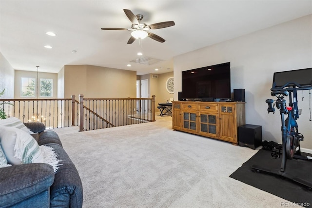 living area with light carpet, a ceiling fan, and recessed lighting