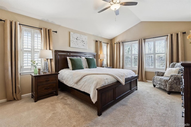 bedroom with baseboards, vaulted ceiling, a ceiling fan, and light colored carpet