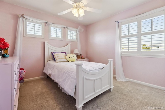 bedroom featuring light carpet, baseboards, and a ceiling fan