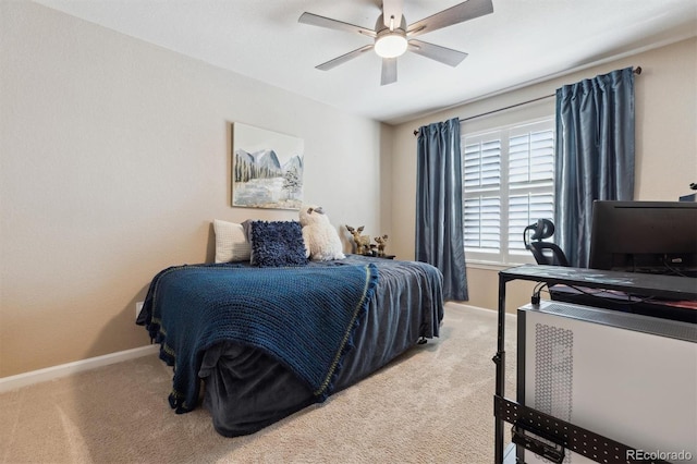 carpeted bedroom featuring ceiling fan and baseboards