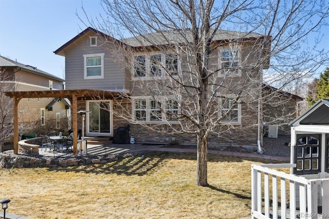 back of property featuring entry steps, a patio area, and a lawn