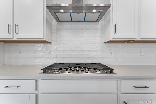 16975 W 92nd Loop, Arvada, CO 80007 - kitchen featuring range hood, stainless steel gas stovetop, light countertops, and white cabinetry