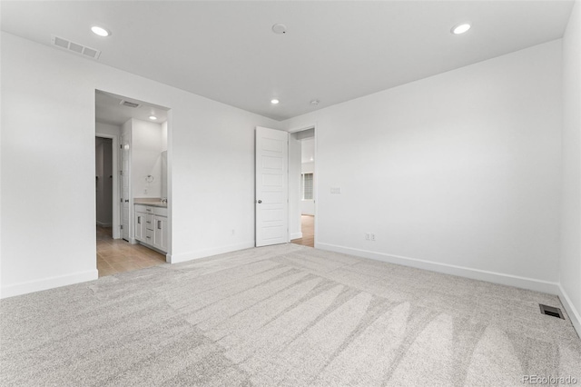 16975 W 92nd Loop, Arvada, CO 80007 - unfurnished bedroom with light colored carpet, recessed lighting, baseboards, and connected bathroom