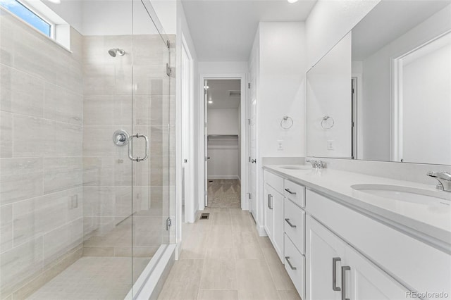 16975 W 92nd Loop, Arvada, CO 80007 - full bathroom with a stall shower, double vanity, and a walk in closet