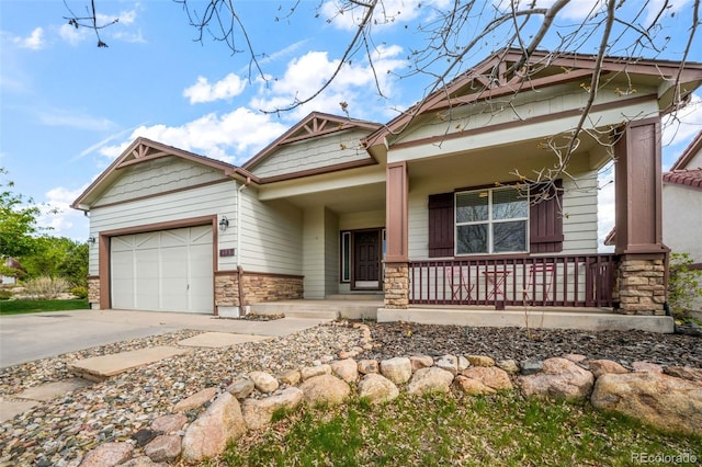 4197 Purple Plum Way, Colorado Springs, CO 80920 - craftsman-style home featuring stone siding, a porch, a garage, and driveway