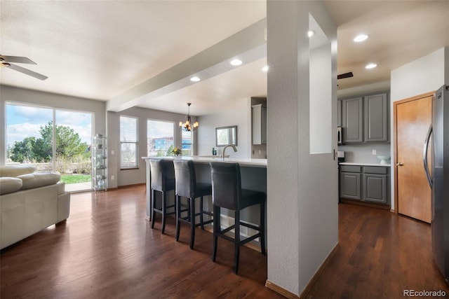 4197 Purple Plum Way, Colorado Springs, CO 80920 - kitchen with open floor plan, gray cabinetry, freestanding refrigerator, dark wood-style flooring, and a peninsula