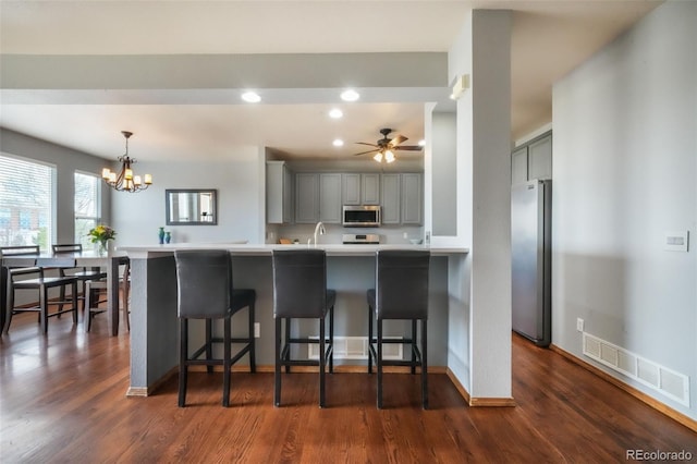 4197 Purple Plum Way, Colorado Springs, CO 80920 - kitchen with stainless steel appliances, gray cabinetry, recessed lighting, a kitchen breakfast bar, and light countertops