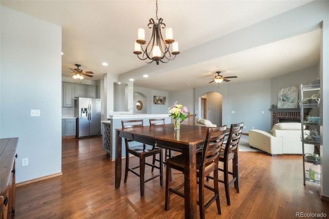4197 Purple Plum Way, Colorado Springs, CO 80920 - dining area with ceiling fan, arched walkways, wood finished floors, recessed lighting, and a brick fireplace