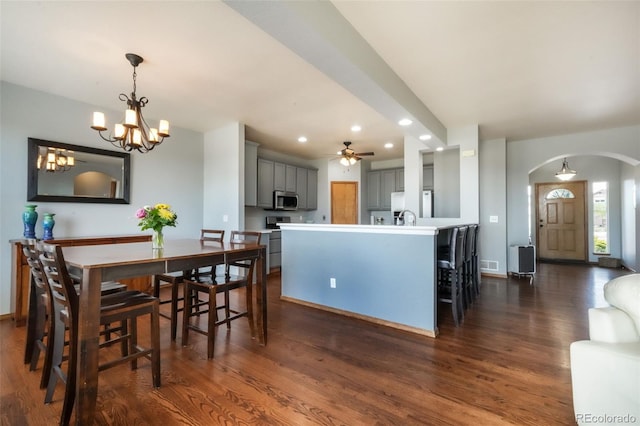 4197 Purple Plum Way, Colorado Springs, CO 80920 - dining space with arched walkways, recessed lighting, dark wood-style floors, ceiling fan, and a chandelier