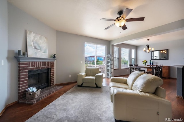 4197 Purple Plum Way, Colorado Springs, CO 80920 - living room featuring a chandelier, ceiling fan, wood finished floors, a brick fireplace, and baseboards