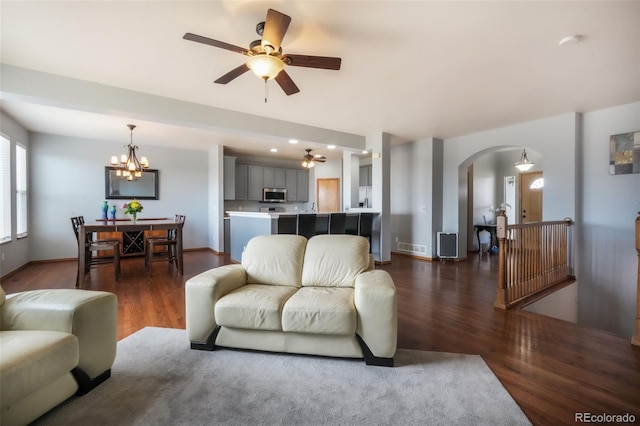 4197 Purple Plum Way, Colorado Springs, CO 80920 - living area with dark wood-type flooring, ceiling fan, arched walkways, and a chandelier