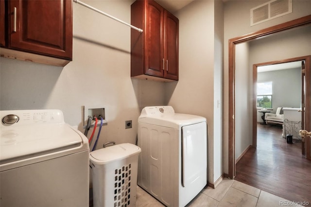 4197 Purple Plum Way, Colorado Springs, CO 80920 - clothes washing area featuring cabinet space, light tile patterned floors, and washing machine and dryer
