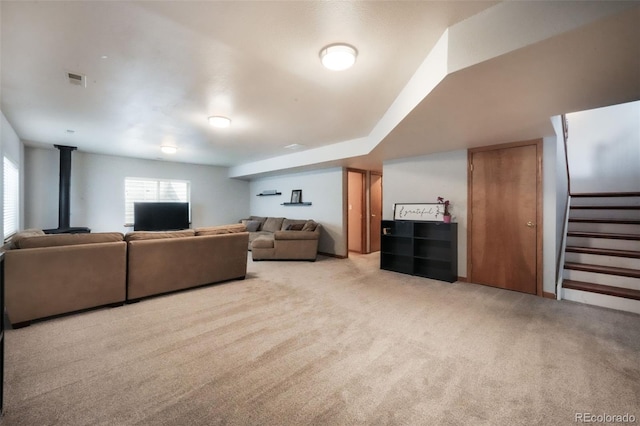 4197 Purple Plum Way, Colorado Springs, CO 80920 - living area with carpet flooring, stairs, and a wood stove