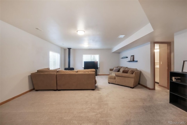 4197 Purple Plum Way, Colorado Springs, CO 80920 - living room featuring a wood stove, light colored carpet, and baseboards