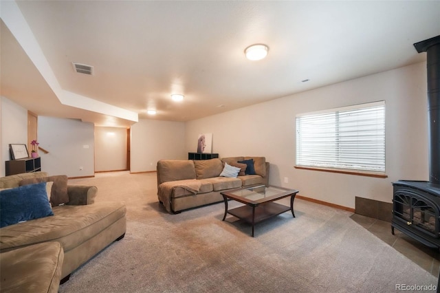 4197 Purple Plum Way, Colorado Springs, CO 80920 - living room with a wood stove, carpet floors, and baseboards