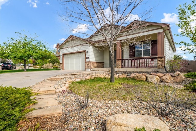 4197 Purple Plum Way, Colorado Springs, CO 80920 - view of front of property featuring covered porch, an attached garage, driveway, and stone siding