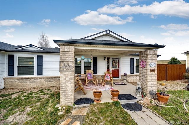 652 Dakota St, Kiowa, CO 80117 - view of front of home with covered porch, fence, and brick siding