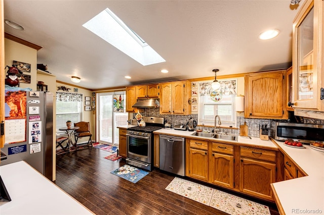 652 Dakota St, Kiowa, CO 80117 - kitchen with appliances with stainless steel finishes, a sink, a skylight, under cabinet range hood, and light countertops