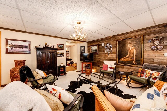 652 Dakota St, Kiowa, CO 80117 - living room with wood walls, ornamental molding, and a chandelier
