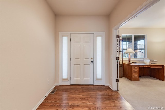entrance foyer featuring light wood-style flooring, baseboards, and visible vents