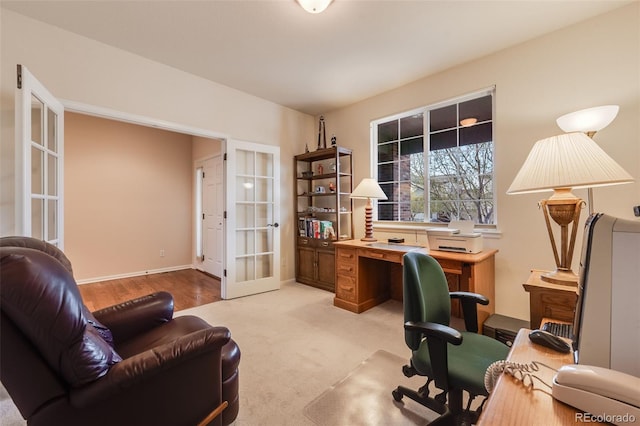 office with french doors and light carpet