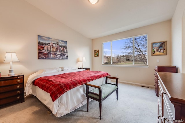 carpeted bedroom with baseboards, lofted ceiling, and visible vents