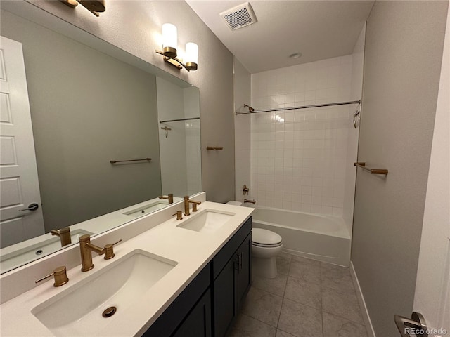 full bathroom with vanity, tile patterned flooring, tiled shower / bath combo, and toilet