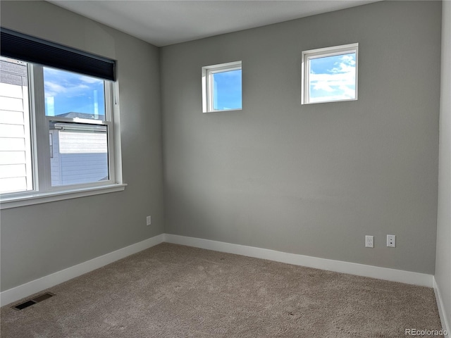 unfurnished room featuring light carpet