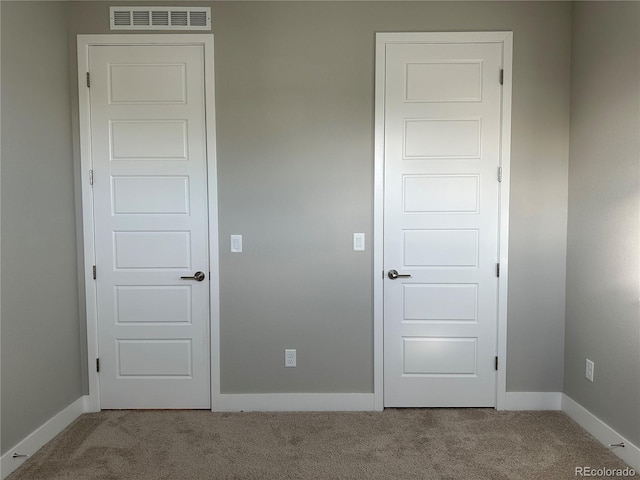 unfurnished room with light carpet