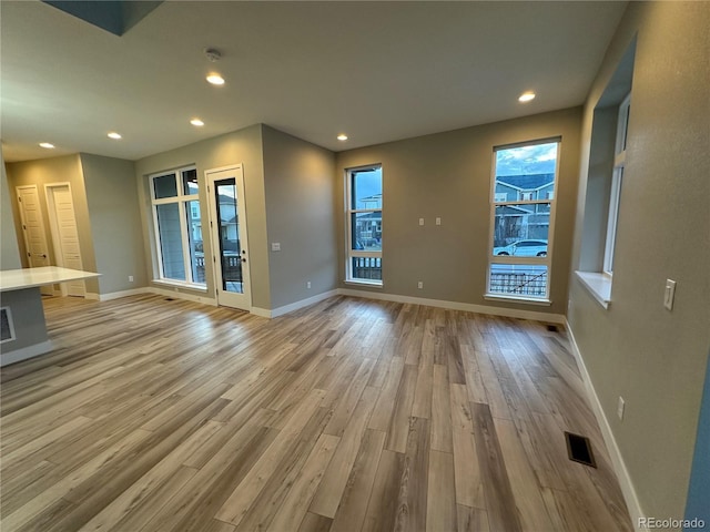 unfurnished living room featuring light wood-type flooring