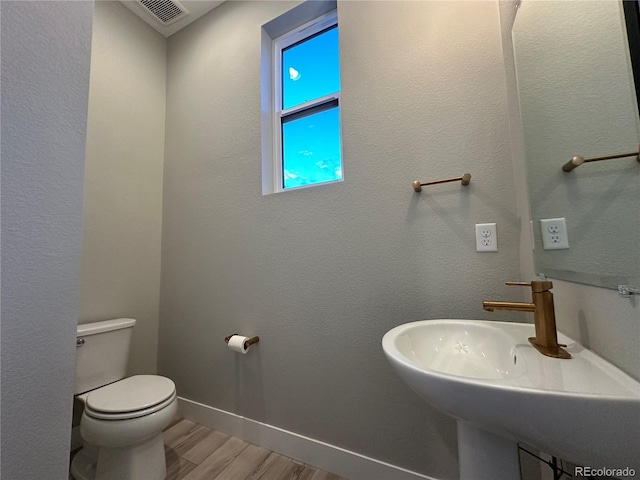 bathroom with sink, wood-type flooring, and toilet