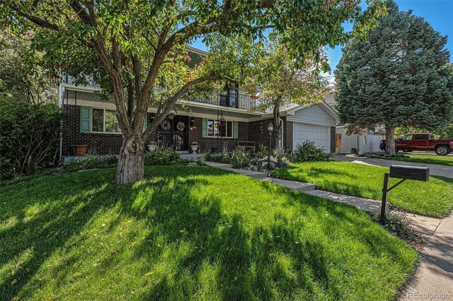 7622 E Nassau Ave, Denver, CO 80237 - view of front of property with brick siding, driveway, a front yard, and a garage