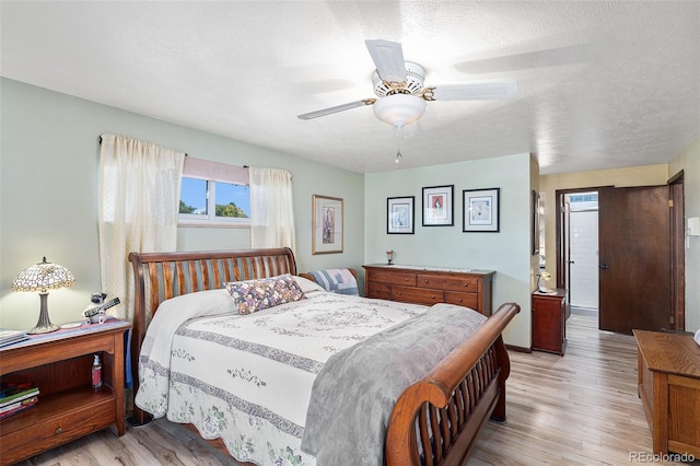 7622 E Nassau Ave, Denver, CO 80237 - bedroom featuring light wood-style floors, a textured ceiling, and ceiling fan