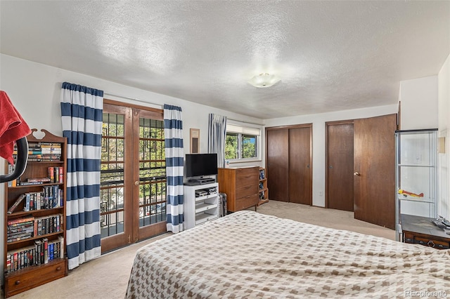 7622 E Nassau Ave, Denver, CO 80237 - carpeted bedroom with two closets and a textured ceiling