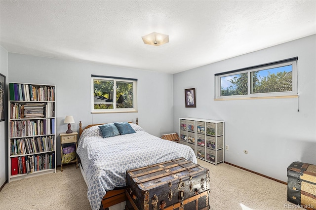 7622 E Nassau Ave, Denver, CO 80237 - bedroom with multiple windows, carpet flooring, and a textured ceiling