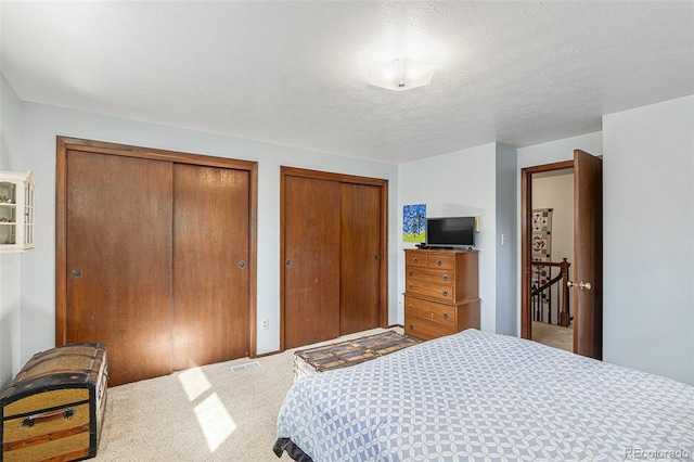 7622 E Nassau Ave, Denver, CO 80237 - bedroom with multiple closets and carpet floors